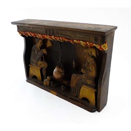 1510 - An early 20thC Continental folk art diorama depicting a naive carved interior scene with man and wom... 