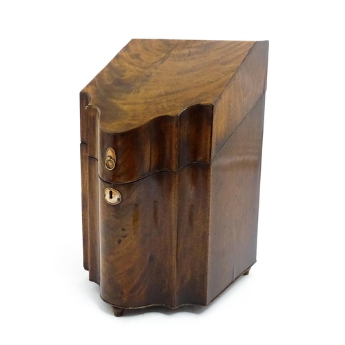 1518 - A 19thC mahogany knife box with a serpentine front opening to reveal a fitted interior, and raised o... 