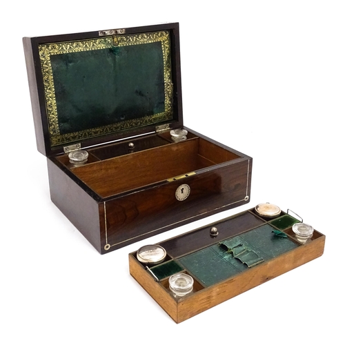 1536 - A Victorian rosewood dressing box with inlaid mother of pearl decoration, opening to reveal a fitted... 