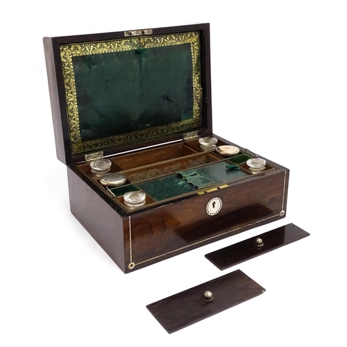 1536 - A Victorian rosewood dressing box with inlaid mother of pearl decoration, opening to reveal a fitted... 