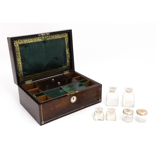 1536 - A Victorian rosewood dressing box with inlaid mother of pearl decoration, opening to reveal a fitted... 