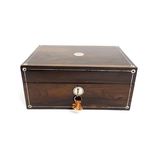 1536 - A Victorian rosewood dressing box with inlaid mother of pearl decoration, opening to reveal a fitted... 