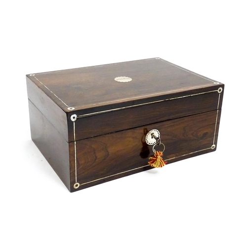 1536 - A Victorian rosewood dressing box with inlaid mother of pearl decoration, opening to reveal a fitted... 