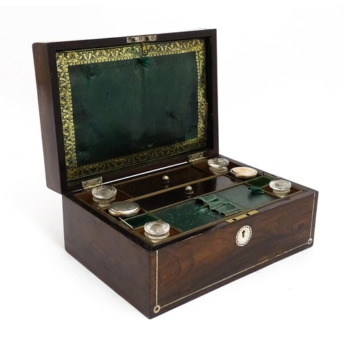 1536 - A Victorian rosewood dressing box with inlaid mother of pearl decoration, opening to reveal a fitted... 