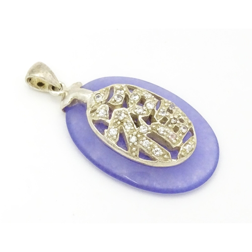 967 - An Oriental purple hardstone pendant set with white stones with silver mount. Approx.  1 1/2