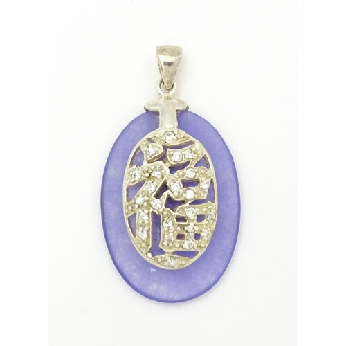 967 - An Oriental purple hardstone pendant set with white stones with silver mount. Approx.  1 1/2