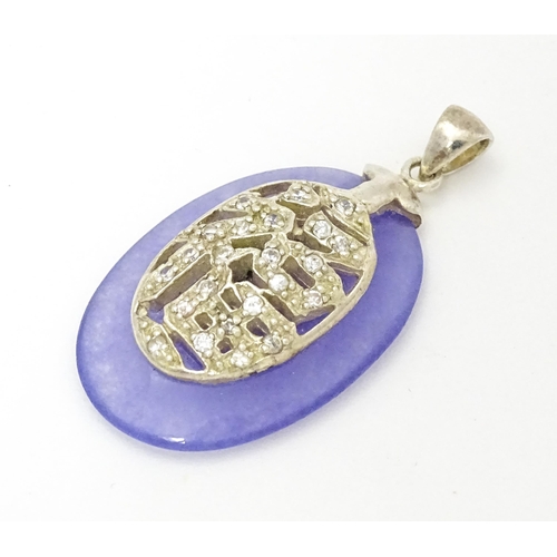 967 - An Oriental purple hardstone pendant set with white stones with silver mount. Approx.  1 1/2