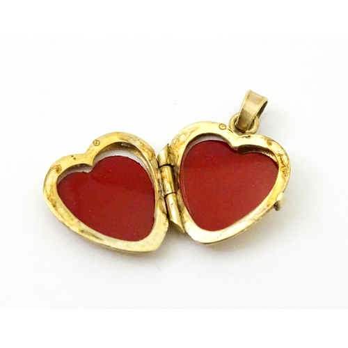 971 - A 9ct gold locket of heart form. Together with a pair of 9ct drop earrings, and an associated pendan... 