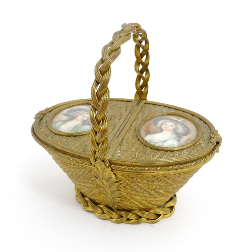 1445 - A 20thC gilt metal sewing / jewellery box of basket form with twin hinged lids each with a hand pain... 