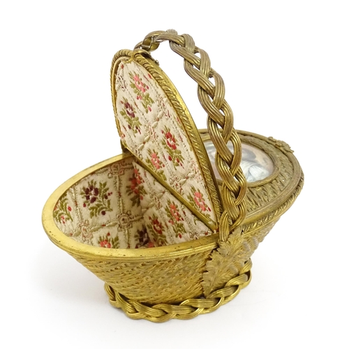 1445 - A 20thC gilt metal sewing / jewellery box of basket form with twin hinged lids each with a hand pain... 