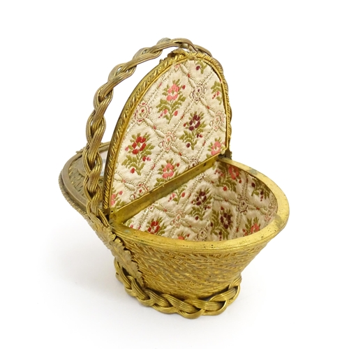 1445 - A 20thC gilt metal sewing / jewellery box of basket form with twin hinged lids each with a hand pain... 