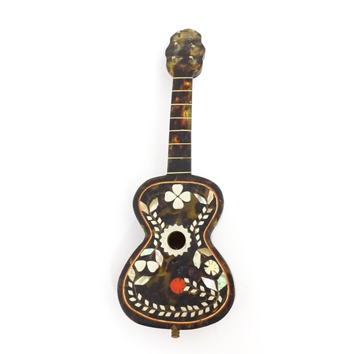 1447 - A 20thC Italian / Napoli souvenir music box modelled as a guitar with inlaid abalone decoration with... 