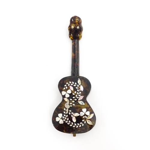 1447 - A 20thC Italian / Napoli souvenir music box modelled as a guitar with inlaid abalone decoration with... 