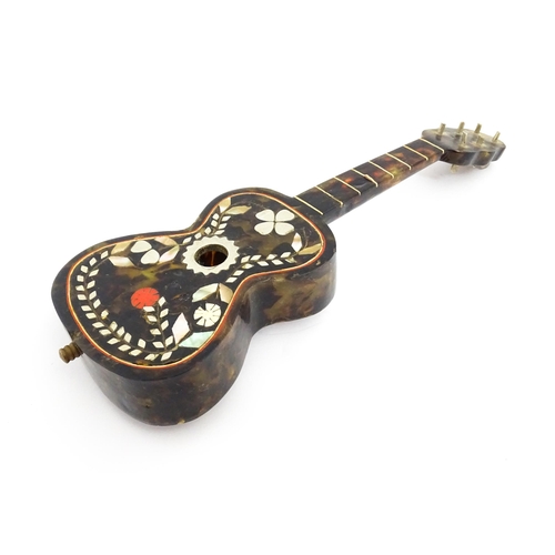 1447 - A 20thC Italian / Napoli souvenir music box modelled as a guitar with inlaid abalone decoration with... 