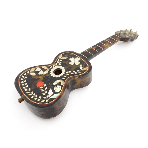 1447 - A 20thC Italian / Napoli souvenir music box modelled as a guitar with inlaid abalone decoration with... 