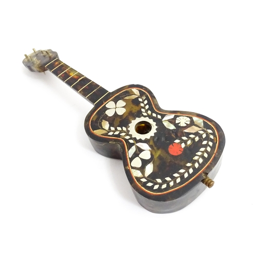 1447 - A 20thC Italian / Napoli souvenir music box modelled as a guitar with inlaid abalone decoration with... 