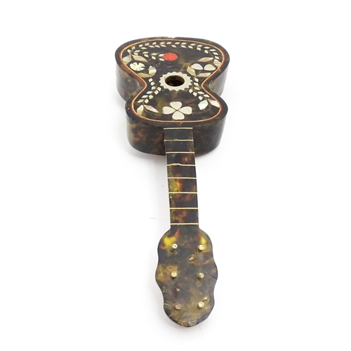 1447 - A 20thC Italian / Napoli souvenir music box modelled as a guitar with inlaid abalone decoration with... 