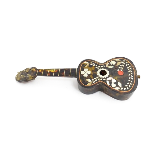 1447 - A 20thC Italian / Napoli souvenir music box modelled as a guitar with inlaid abalone decoration with... 