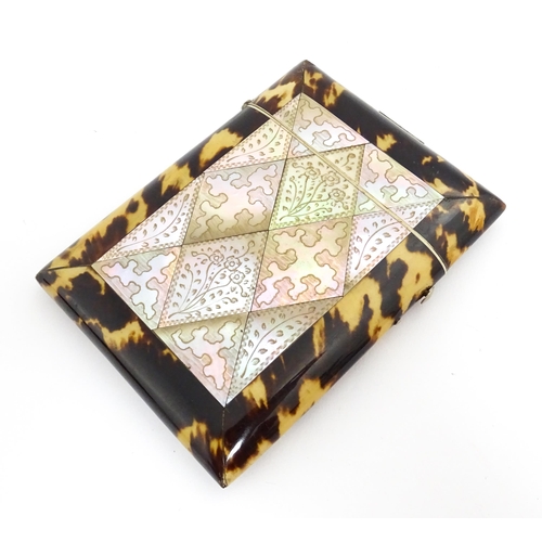 1450 - A Victorian tortoiseshell and mother of pearl card case with engraved floral decoration. Approx. 4