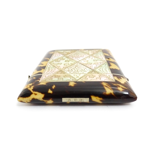 1450 - A Victorian tortoiseshell and mother of pearl card case with engraved floral decoration. Approx. 4