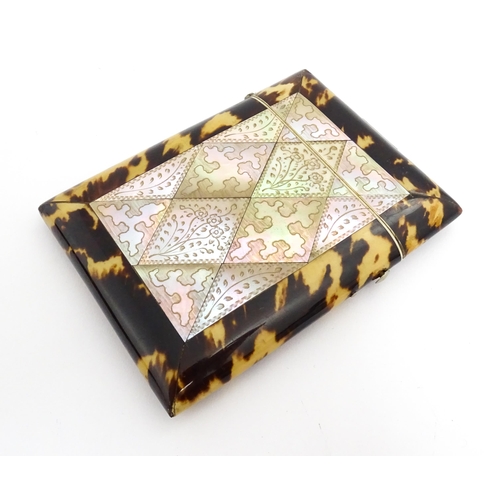 1450 - A Victorian tortoiseshell and mother of pearl card case with engraved floral decoration. Approx. 4