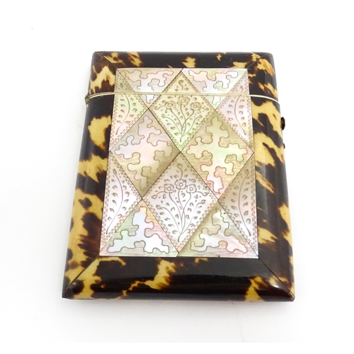 1450 - A Victorian tortoiseshell and mother of pearl card case with engraved floral decoration. Approx. 4