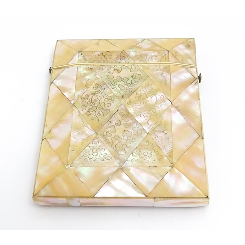 1452 - A Victorian mother of pearl card case with engraved floral decoration. Approx. 4