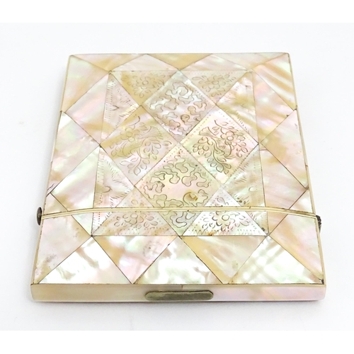 1452 - A Victorian mother of pearl card case with engraved floral decoration. Approx. 4