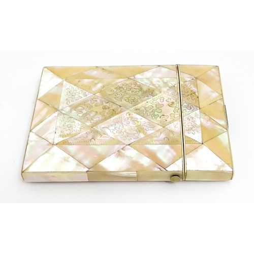 1452 - A Victorian mother of pearl card case with engraved floral decoration. Approx. 4