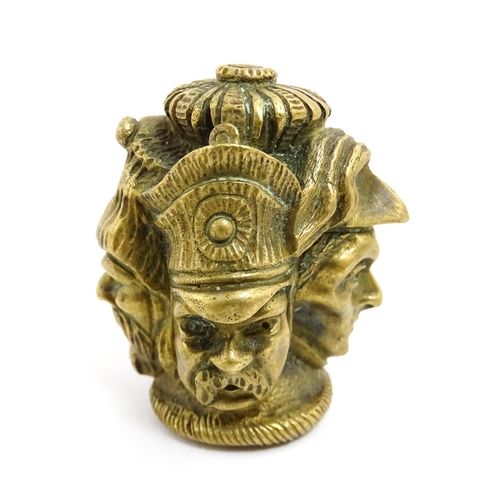 1455 - A 20thC cast brass cane top with multi face detail depicting four military figures. Approx. 1 3/4