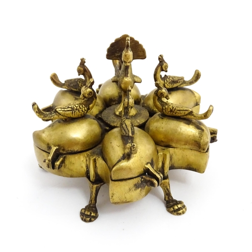 1457 - A 20thC Indian brass travelling spice box comprised of five sections with peacock bird finials, rais... 