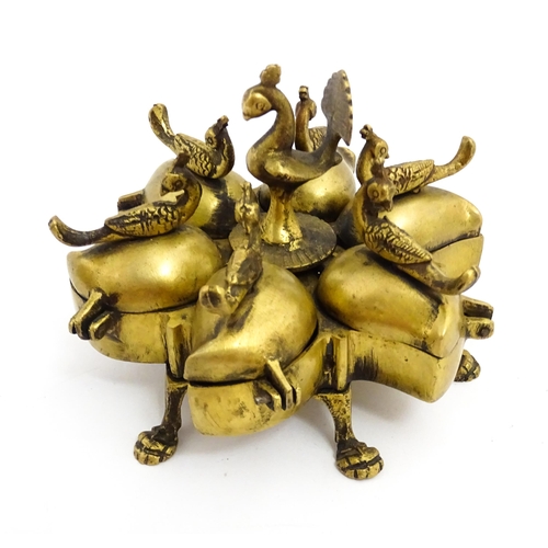 1457 - A 20thC Indian brass travelling spice box comprised of five sections with peacock bird finials, rais... 