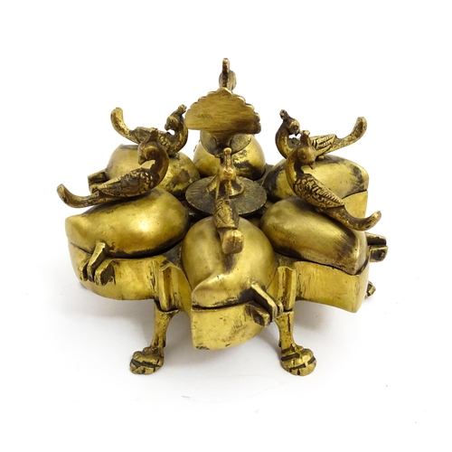 1457 - A 20thC Indian brass travelling spice box comprised of five sections with peacock bird finials, rais... 