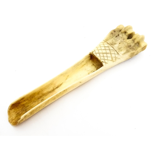 1465 - A 19thC carved knuckle bone apple corer with crosshatched decoration. Together with a treen pot and ... 