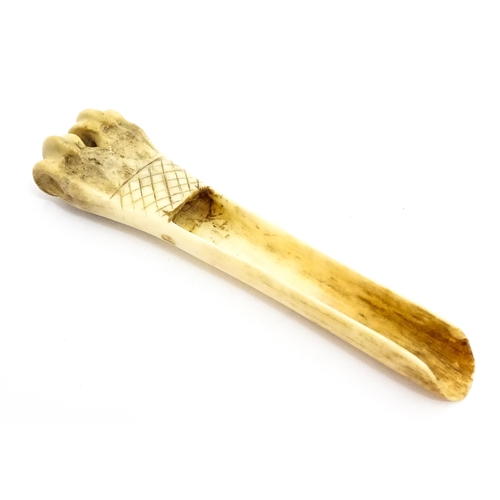 1465 - A 19thC carved knuckle bone apple corer with crosshatched decoration. Together with a treen pot and ... 