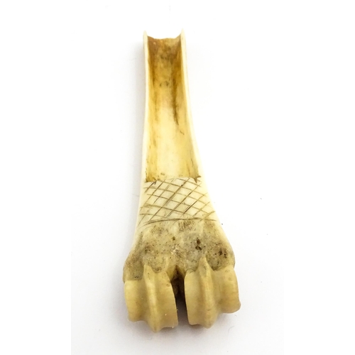 1465 - A 19thC carved knuckle bone apple corer with crosshatched decoration. Together with a treen pot and ... 