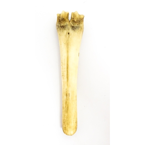 1465 - A 19thC carved knuckle bone apple corer with crosshatched decoration. Together with a treen pot and ... 