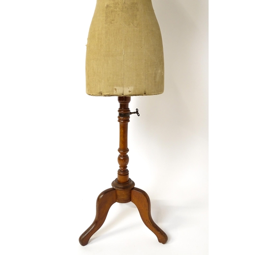 1199 - A tailor's / dressmaker's mannequin, revolving on a turned tripod base, approx 62 1/2