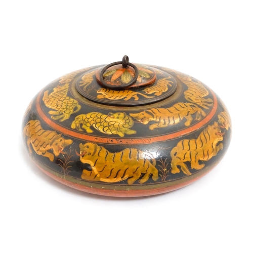 1540 - An Asian wooden box / container of circular form with lacquered and hand painted decoration depictin... 