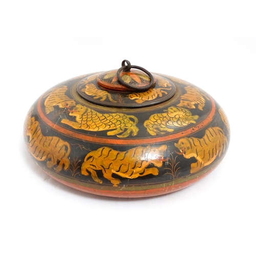 1540 - An Asian wooden box / container of circular form with lacquered and hand painted decoration depictin... 