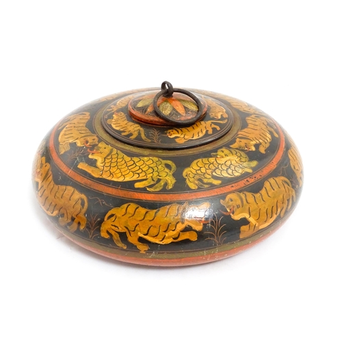 1540 - An Asian wooden box / container of circular form with lacquered and hand painted decoration depictin... 