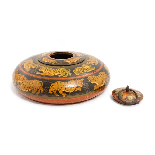 1540 - An Asian wooden box / container of circular form with lacquered and hand painted decoration depictin... 