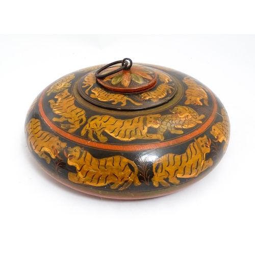 1540 - An Asian wooden box / container of circular form with lacquered and hand painted decoration depictin... 