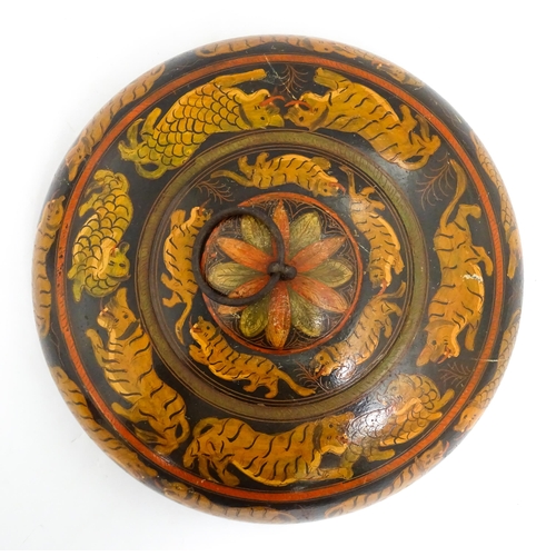 1540 - An Asian wooden box / container of circular form with lacquered and hand painted decoration depictin... 