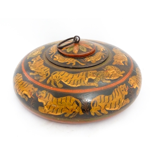 1540 - An Asian wooden box / container of circular form with lacquered and hand painted decoration depictin... 