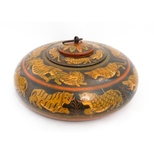 1540 - An Asian wooden box / container of circular form with lacquered and hand painted decoration depictin... 