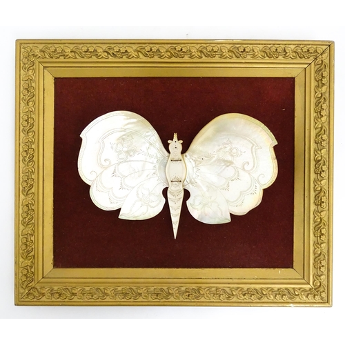 1542 - A 20thC framed mother of peal model of a butterfly with floral and foliate detail. Approx. 13