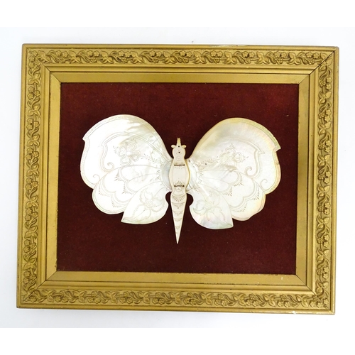 1542 - A 20thC framed mother of peal model of a butterfly with floral and foliate detail. Approx. 13