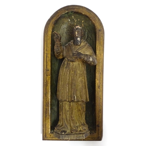 1545 - A late 19th / early 20thC carved wooden plaque depicting Saint Peter in an arched niche. Approx. 14 ... 