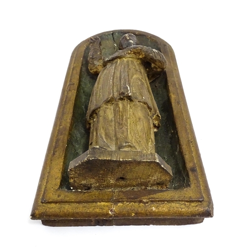 1545 - A late 19th / early 20thC carved wooden plaque depicting Saint Peter in an arched niche. Approx. 14 ... 